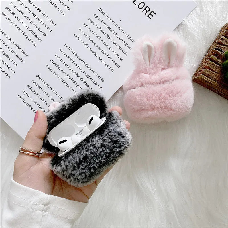 Pink silicone AirPods protective case with plush rabbit ears on charging case
