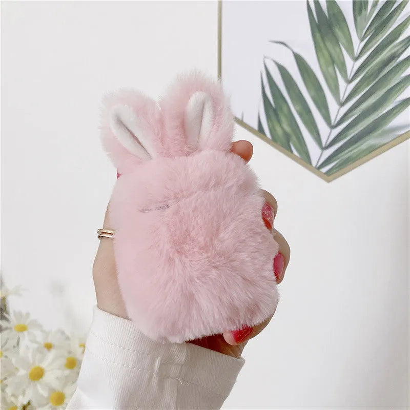 Pink silicone AirPods protective case with plush rabbit ears on charging case