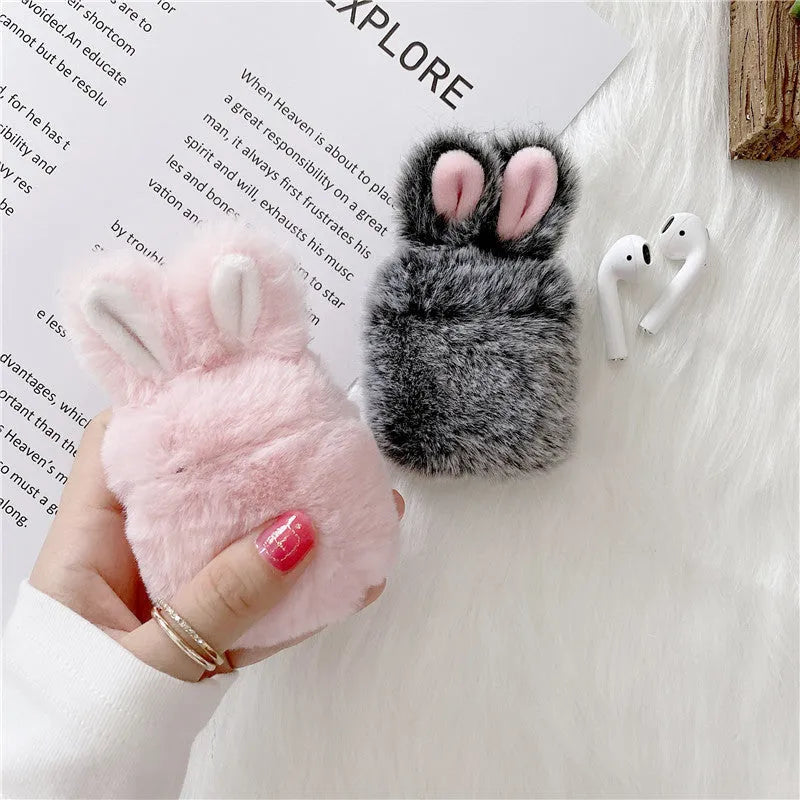 Pink silicone AirPods protective case with plush rabbit ears on charging case