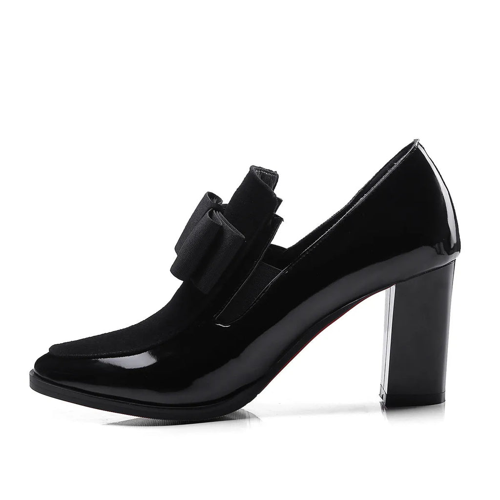 Black patent leather women's high heels with a thick square heel and square toe on a rubber sole.