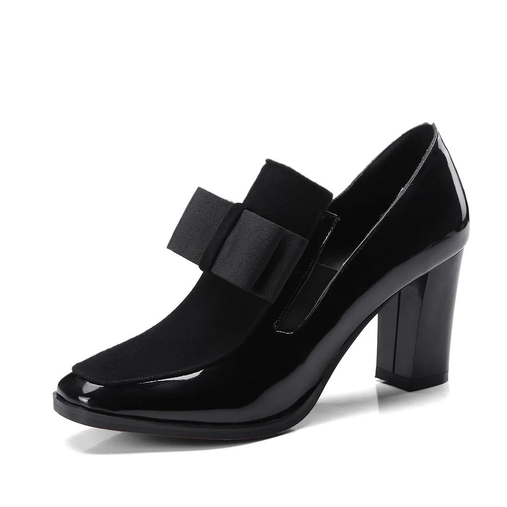 Black patent leather women's high heels with a thick square heel and square toe on a rubber sole.