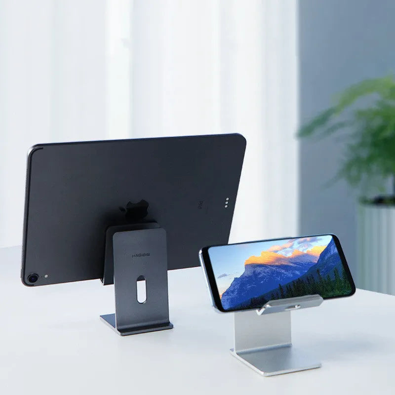 Alloy desktop mobile phone holder bracket in dark space grey colour on wooden desk