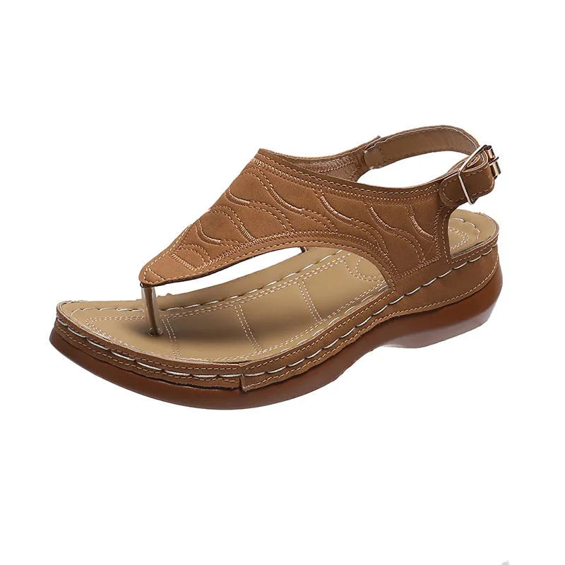 Women's wedge heel flip flop sandals in black with an adjustable back strap and buckle.