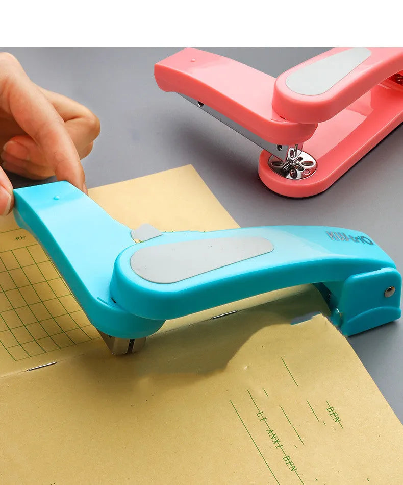 Rotatable student stapler with 360-degree spinning head in dark blue, showing staples loaded and metal outlet.