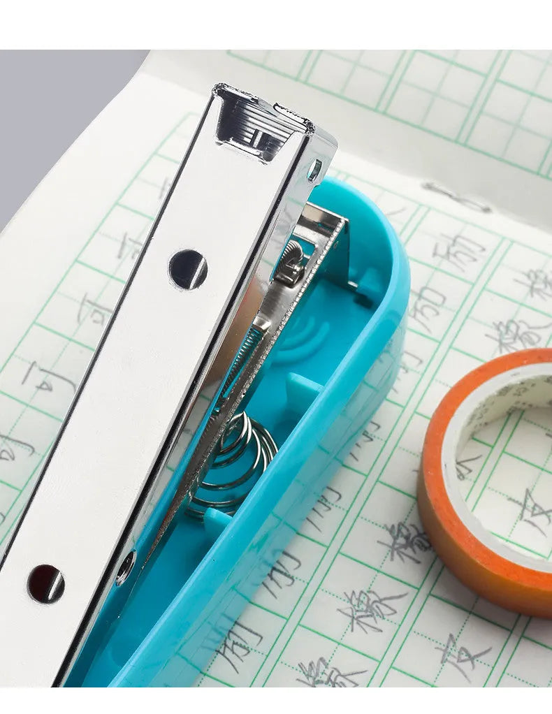 Rotatable student stapler with 360-degree spinning head in dark blue, showing staples loaded and metal outlet.