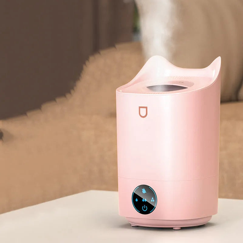 Double spray humidifier with large water tank in coral pink colour, showing three mist outlets