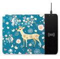 Wireless charging mouse pad with RGB edge lighting and cartoon graphic on black cloth surface.