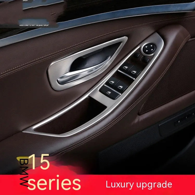 Set of four silver and black decorative trim strips for BMW 5 Series interior door handles.