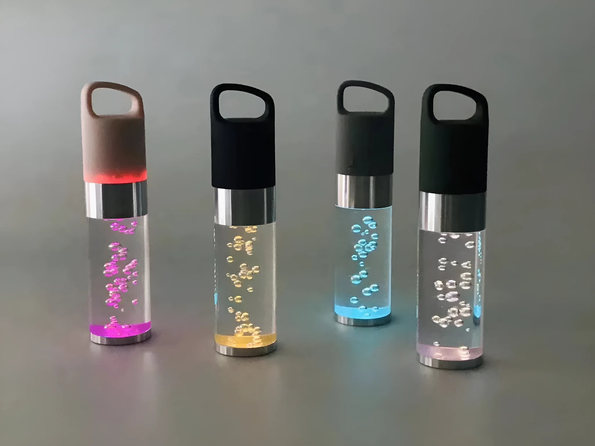 Portable Bluetooth speaker with coloured crystal lights in pink, black, silver grey, or green.