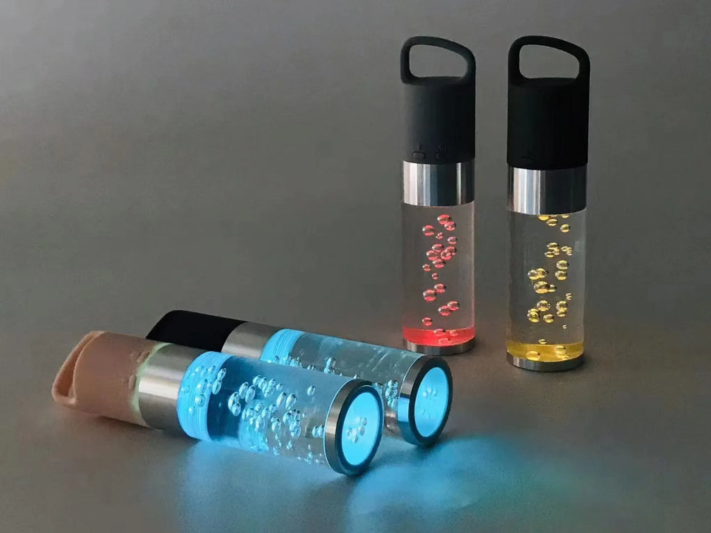Portable Bluetooth speaker with coloured crystal lights in pink, black, silver grey, or green.