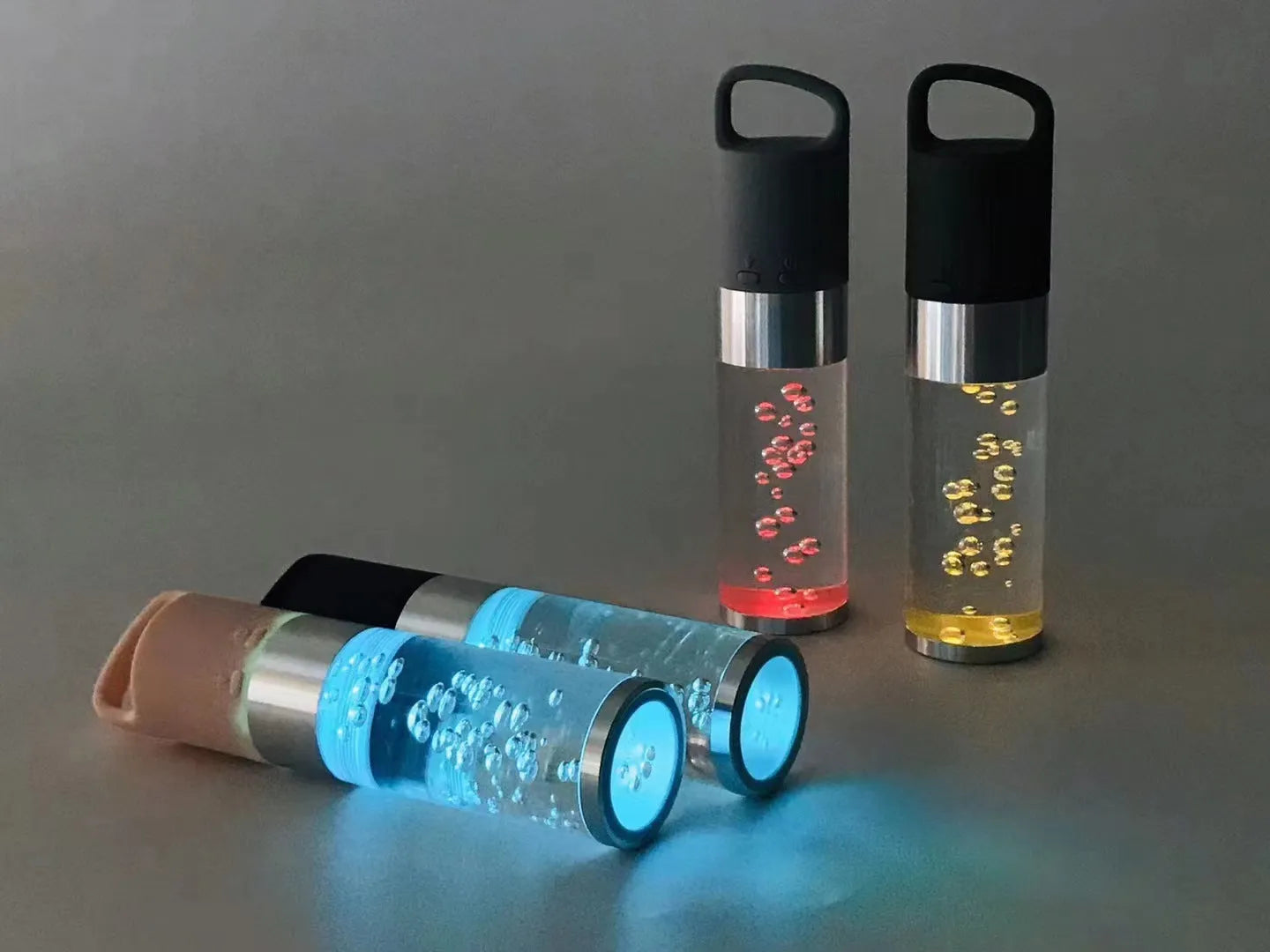 Portable Bluetooth speaker with coloured crystal lights in pink, black, silver grey, or green.