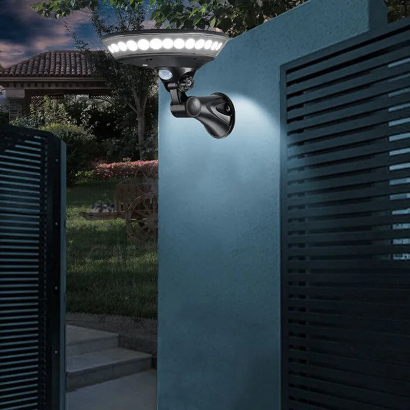 White outdoor solar light with 360-degree dome design on a stake, featuring a top-mounted solar panel.