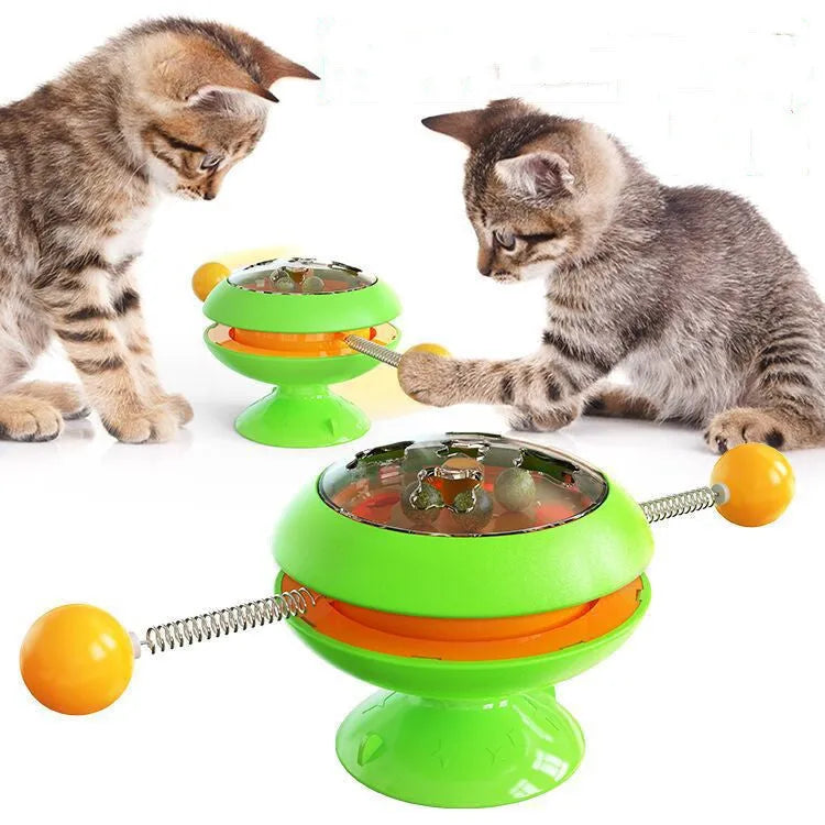 Rotatable plastic cat toy with turntable, funny sticks, and transparent catnip compartment on a suction cup base.