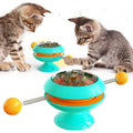 Rotatable plastic cat toy with turntable, funny sticks, and transparent catnip compartment on a suction cup base.