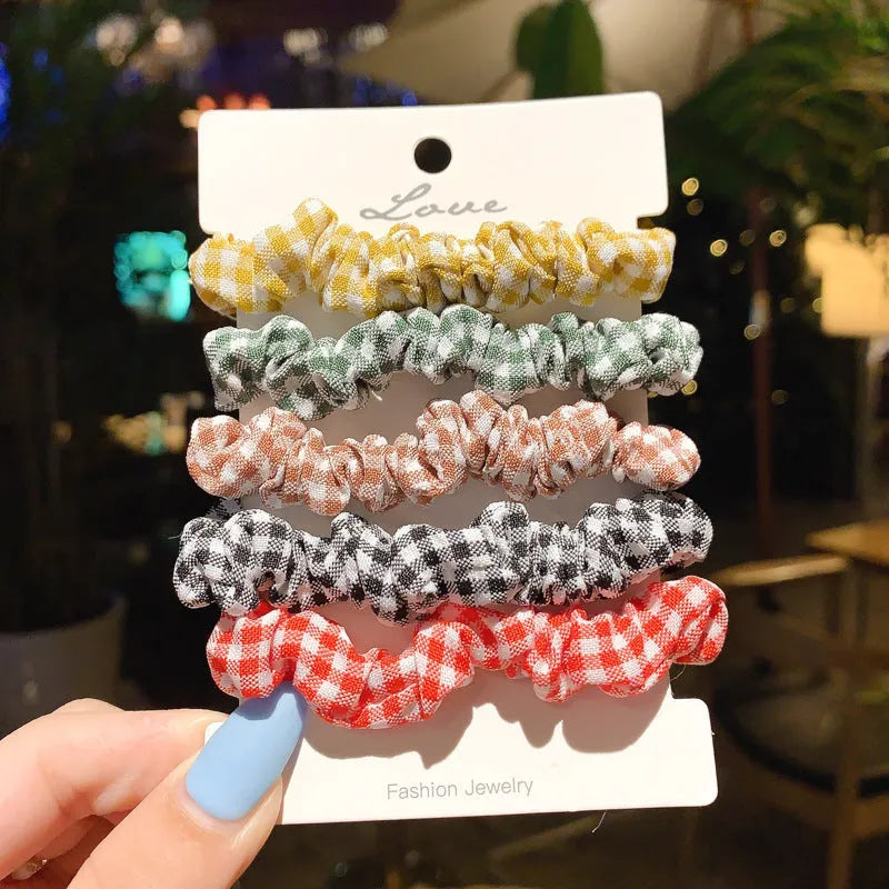 Children's hair accessories set showing autumn colour rings and dark macaron style clips