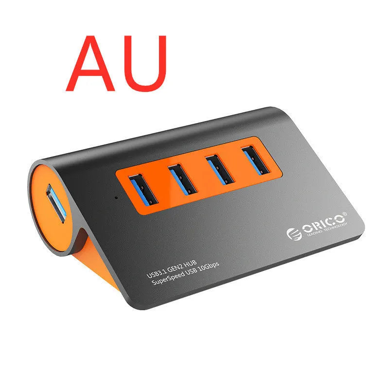 Dark grey aluminium USB hub with four orange-trimmed ports and a long black data cable.