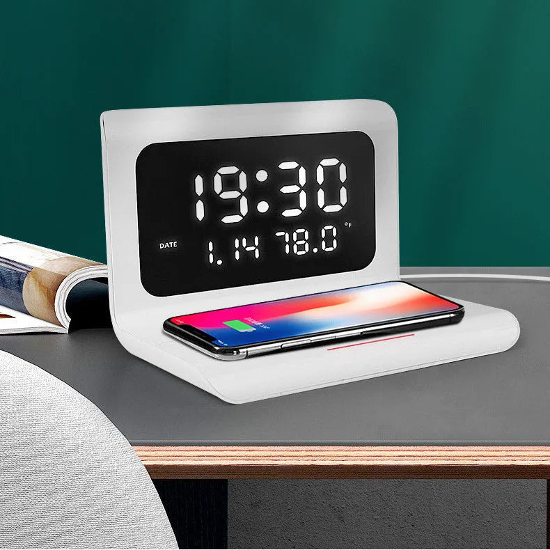 White wireless charger alarm clock showing perpetual calendar display with temperature and humidity readings