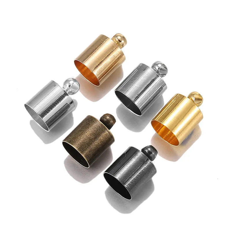 Assorted copper bell caps in gold, silver, and bronze finishes for jewellery making.
