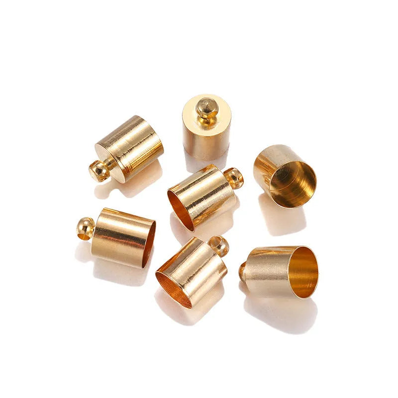 Assorted copper bell caps in gold, silver, and bronze finishes for jewellery making.