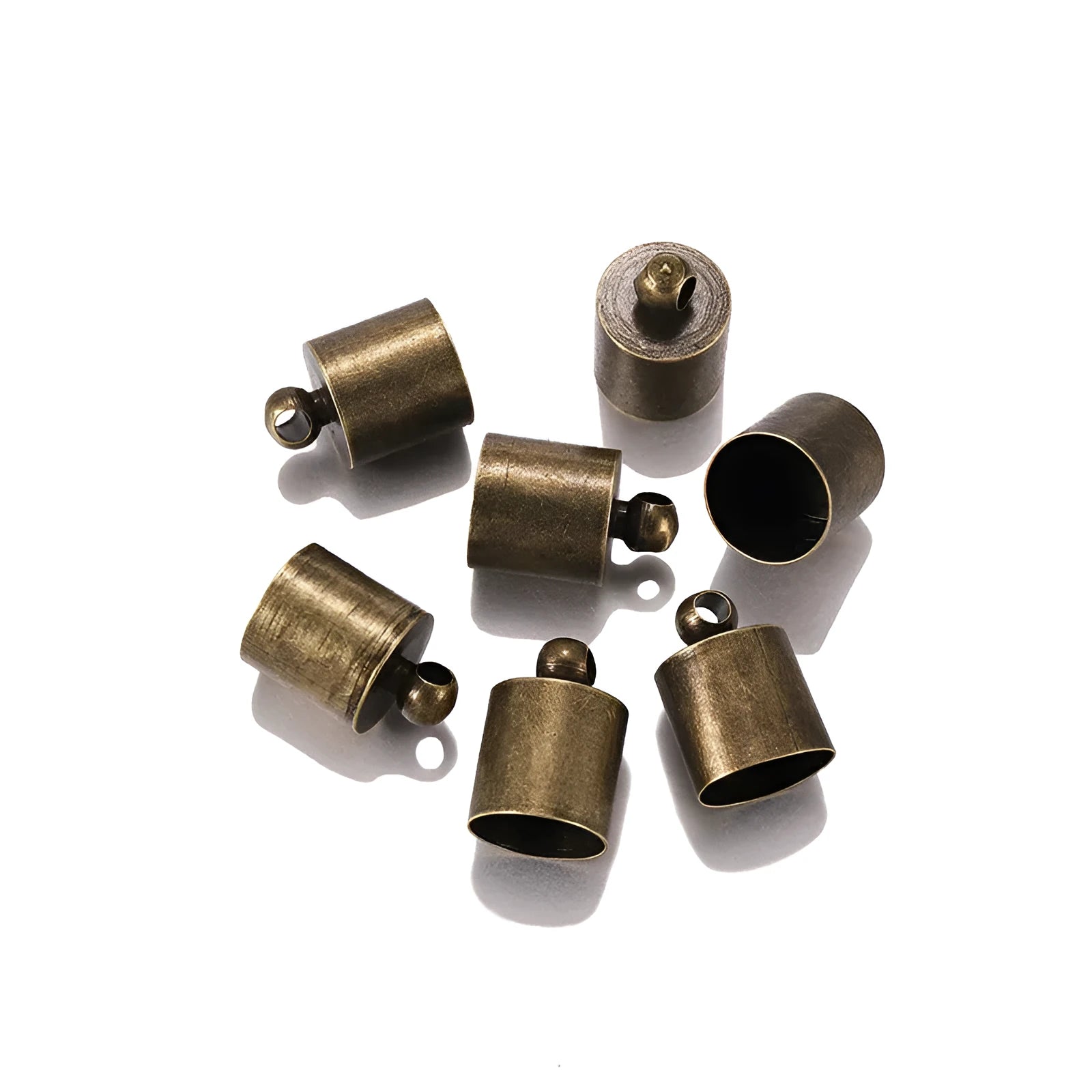 Assorted copper bell caps in gold, silver, and bronze finishes for jewellery making.
