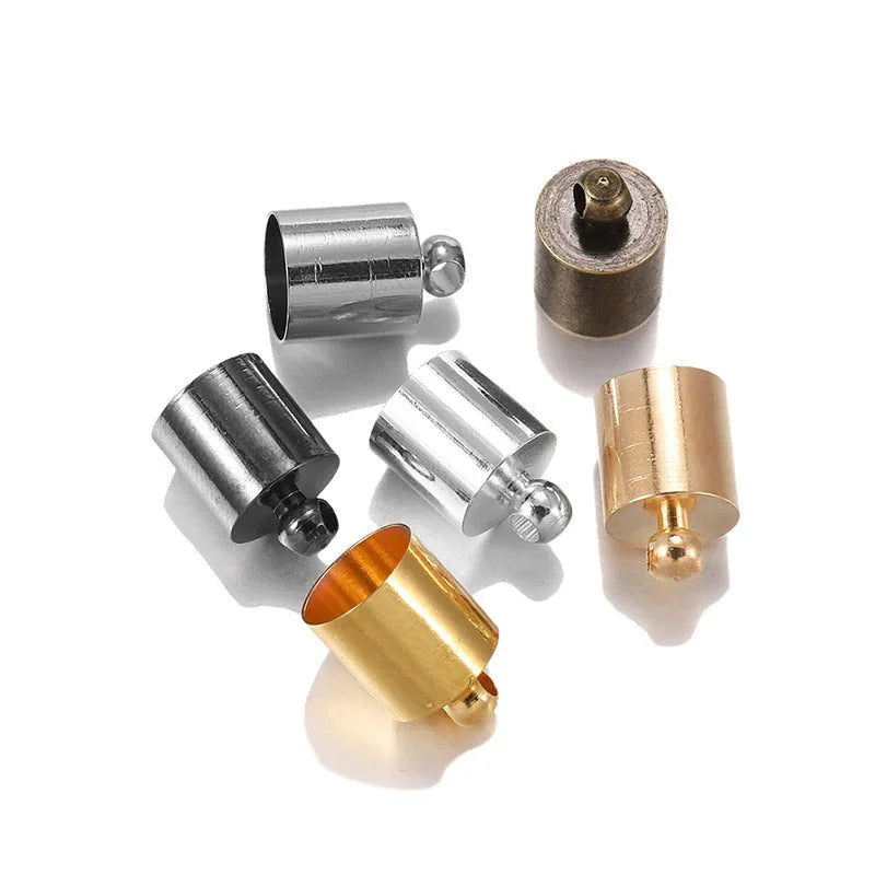 Assorted copper bell caps in gold, silver, and bronze finishes for jewellery making.