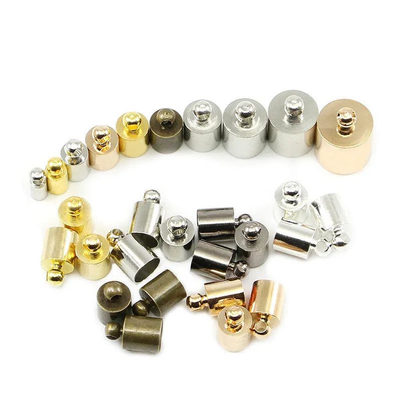 Assorted copper bell caps in gold, silver, and bronze finishes for jewellery making.