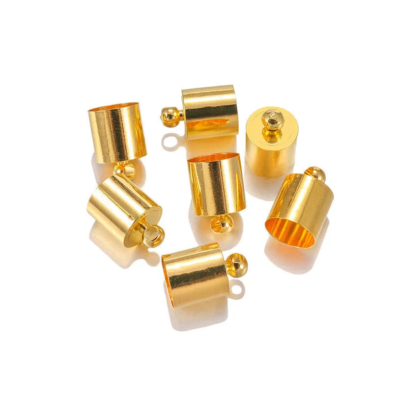 Assorted copper bell caps in gold, silver, and bronze finishes for jewellery making.