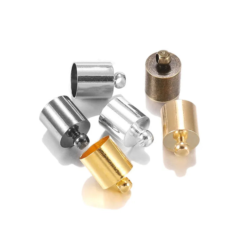 Assorted copper bell caps in gold, silver, and bronze finishes for jewellery making.