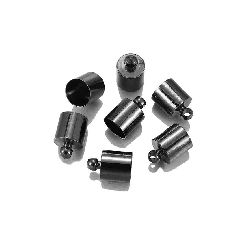 Assorted copper bell caps in gold, silver, and bronze finishes for jewellery making.