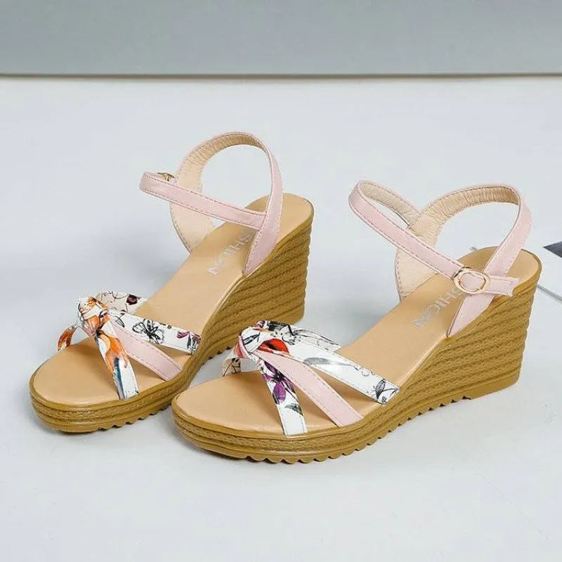 Women's pink wedge sandals with a thick heel, non-slip sole, and a single buckle fastening.