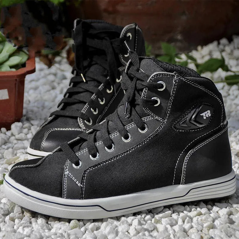 A pair of black casual short motorcycle boots for men, showcasing a breathable summer design with a non-slip sole.