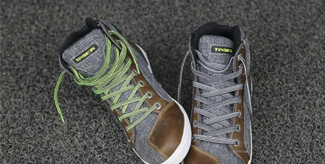 A pair of black casual short motorcycle boots for men, showcasing a breathable summer design with a non-slip sole.