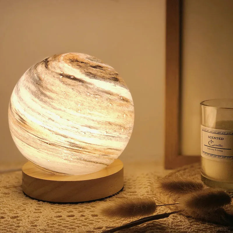 Nordic style bedside table lamp with glass shade on a wooden table, showcasing amber colour option.