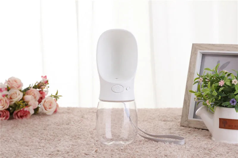 Portable dog and cat water bottle with food grade ABS sink, transparent PC cup, and silicone sealing ring in blue.