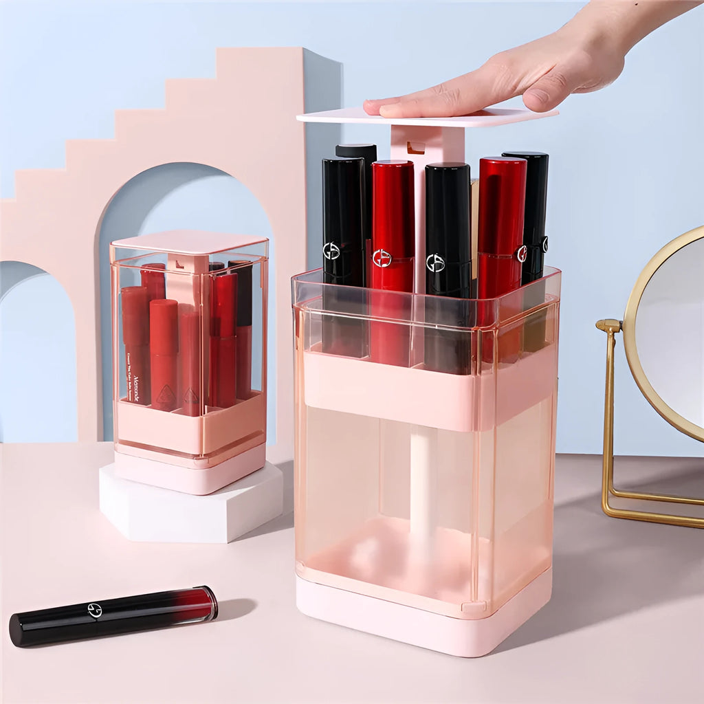 White press lift lipstick storage box with clear dust cover on a desktop, showing organised lipsticks.