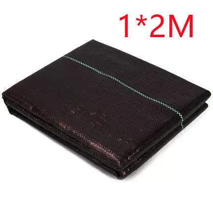 Black composite woven PE weed cloth roll for farmland and greenhouse weed suppression.