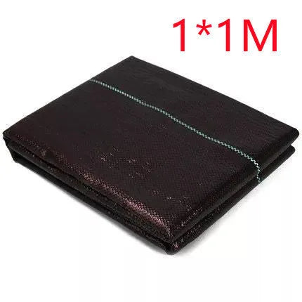Black composite woven PE weed cloth roll for farmland and greenhouse weed suppression.