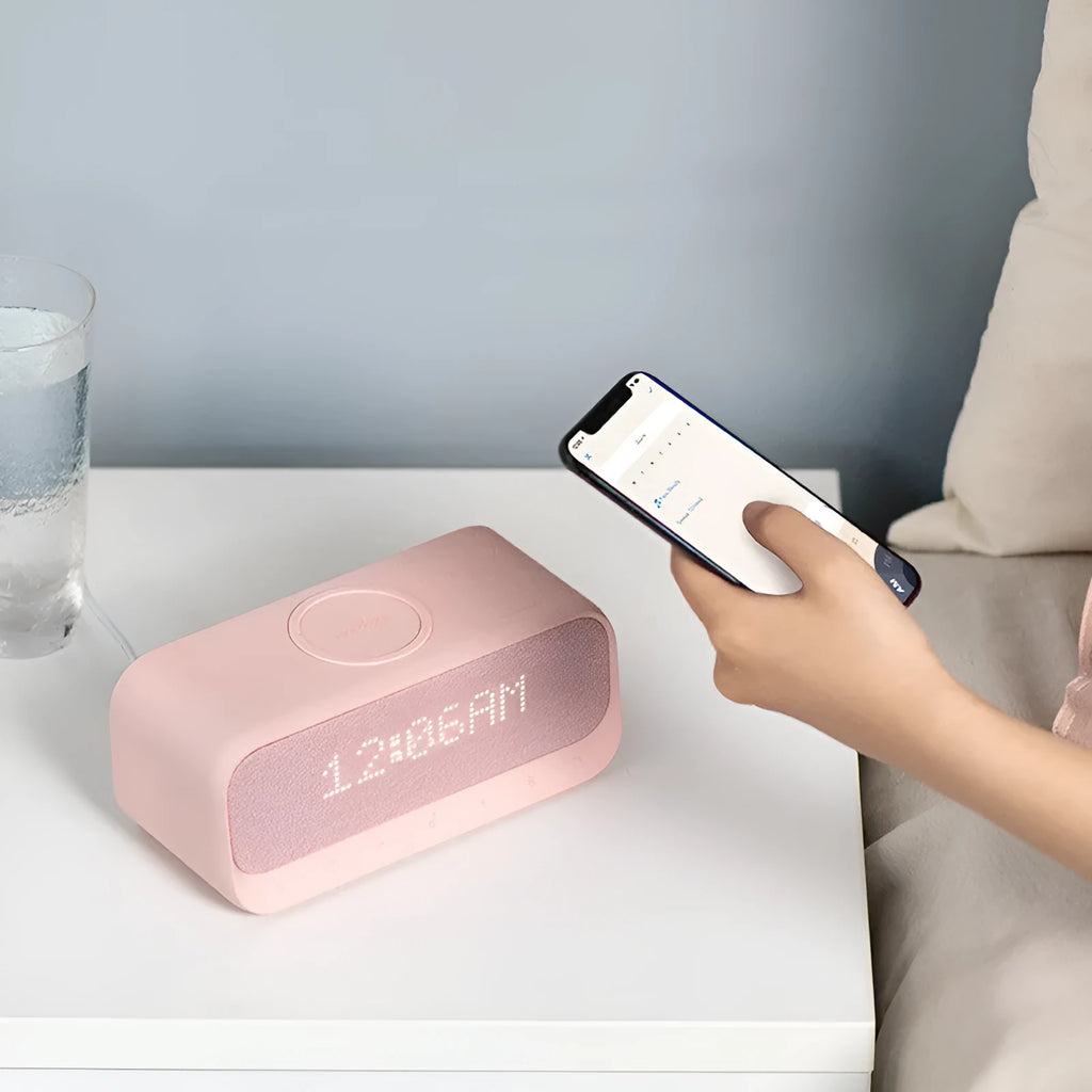 Anker Soundcore pink and white Bluetooth speaker with wireless charging top and LED display