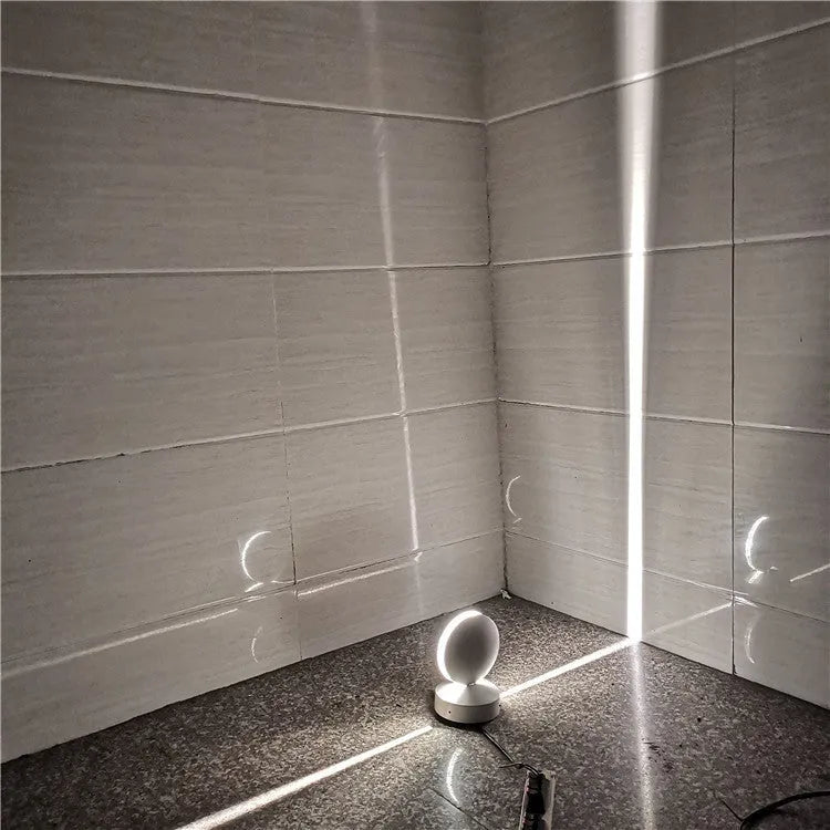 Modern aluminium and glass LED spotlight bar wall lamp mounted on a wall.