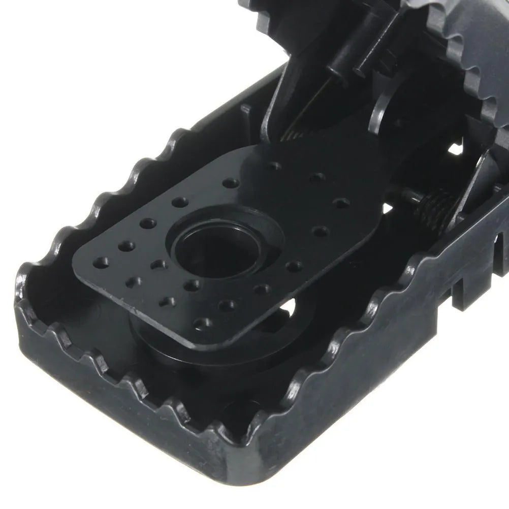 Six black plastic snapping mousetraps showing 11cm length and biting mechanism