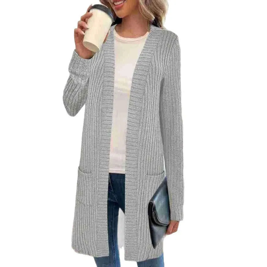 Long sleeve loose fit knitted cardigan jacket with pockets in polyester fabric.