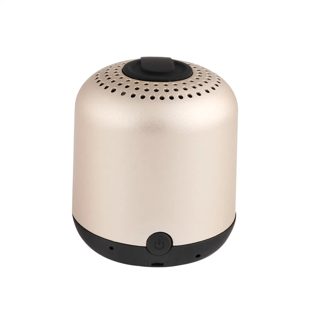 Hieha XQ11 cylindrical mini portable Bluetooth speaker in silver colour on a table.