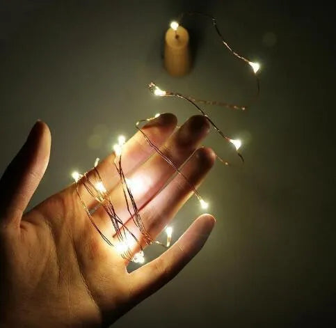 Copper wire LED string light with 20 bulbs inserted into a wine bottle for decorative lighting
