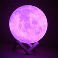 3D printed white moon lamp with textured surface on a wooden stand, showing touch ring at base.