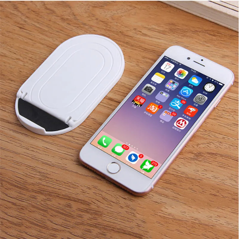 Plastic lazy bracket mobile phone stand showing 360-degree rotation adjustment in multiple colour options