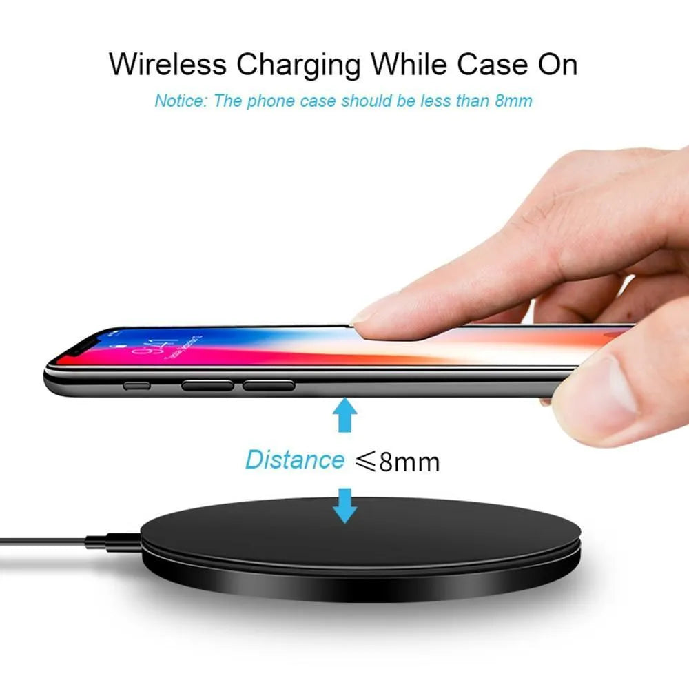 Black ultra-thin 9V QI wireless fast charger with USB cable on a desk.