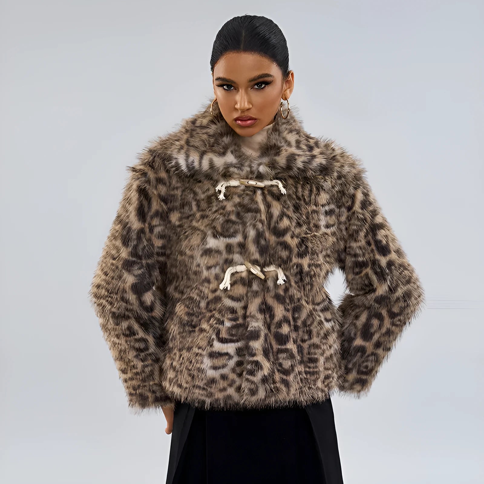 Female leopard print coat with a silver buckle detail on the lapel.