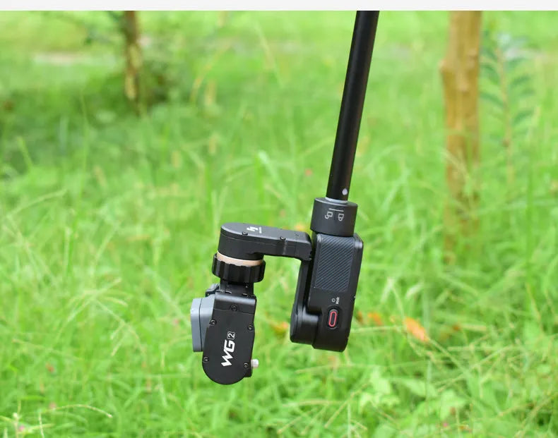Black retractable selfie stick with stabilizer grip extended to full length with phone attached