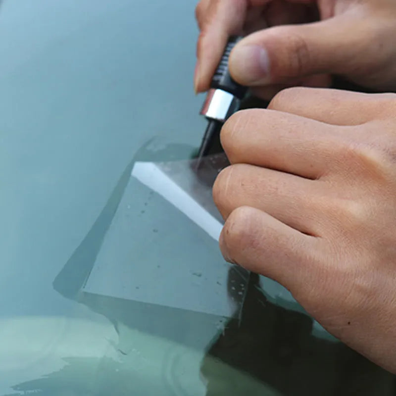 Yellow three-piece car windshield repair kit with glass repair liquid and application tools