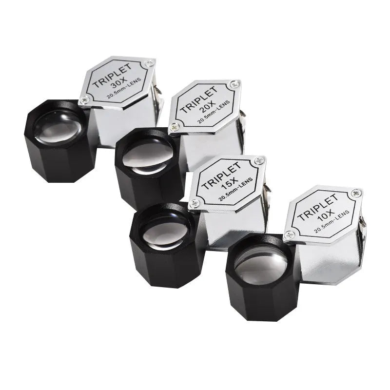 Handheld metal magnifying glass with optical glass lens for jewellery, stamp, and coin identification.
